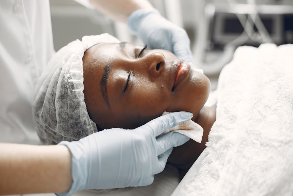 A woman enjoying a calming facial treatment at a spa, promoting relaxation and rejuvenation.
